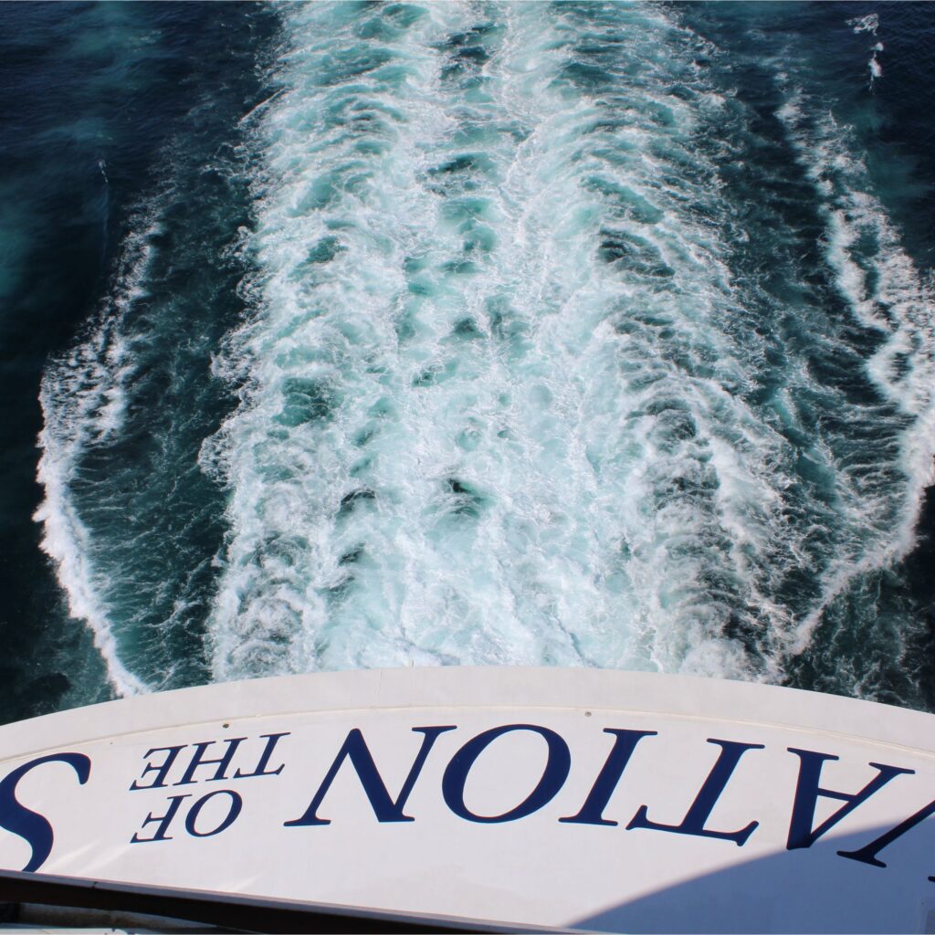 Wake trail on water behind a the Ovation of the Seas.