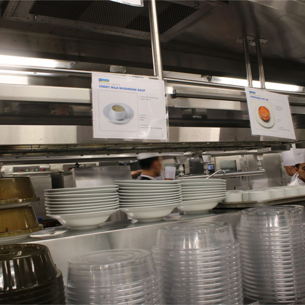 Mushroom soup sign in a kitchen setting with dishes on the counter.