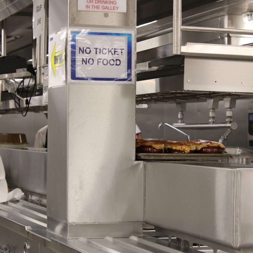 No ticket, no food sign in a kitchen setting.